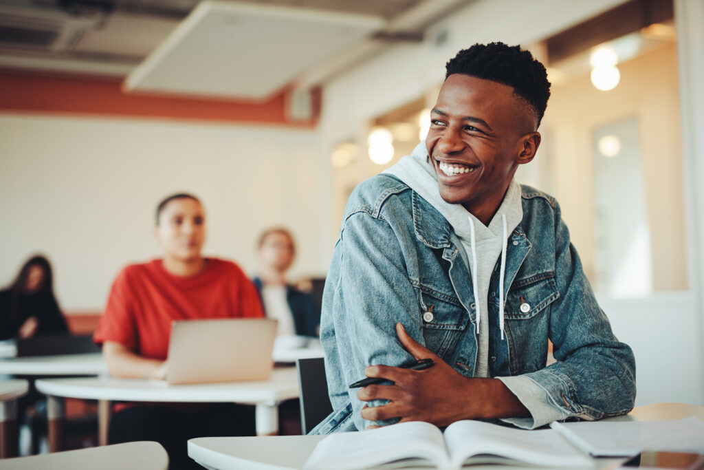 Male student smiling in classroom