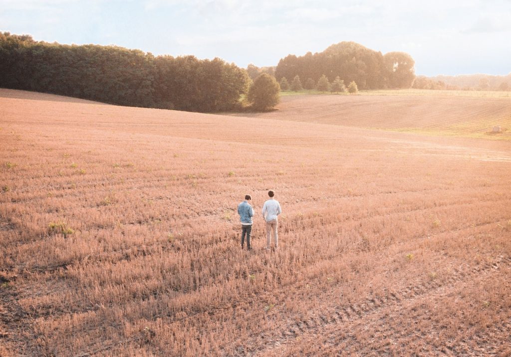 Two men standing in a wheat field