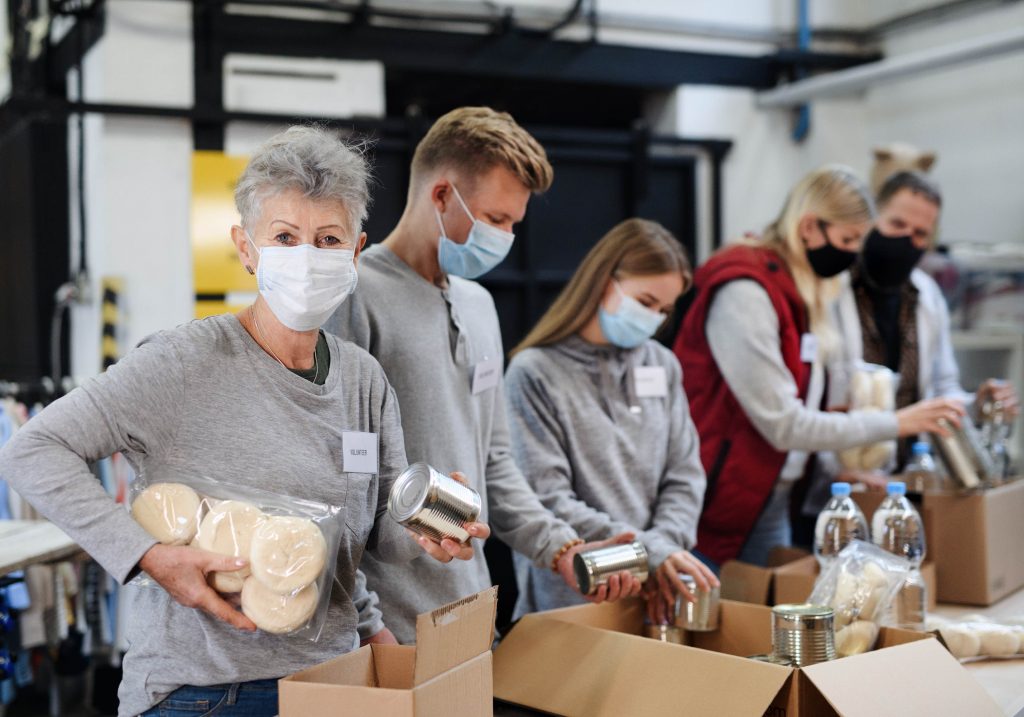 Non-profit volunteers help on a packing line