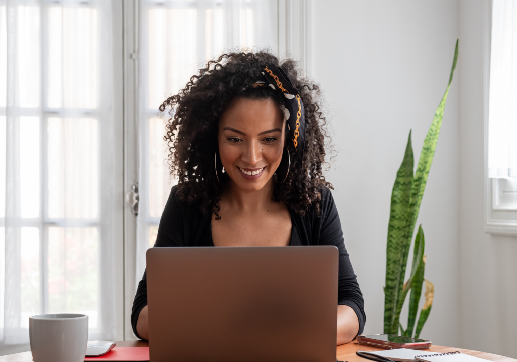 Smiling woman working on laptop