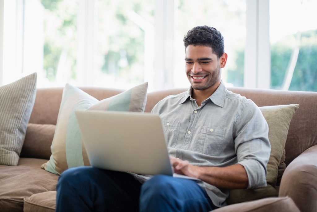 Man sitting on couch with laptop