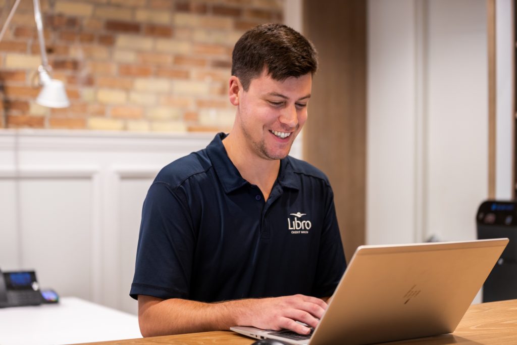 Libro staff in branch on laptop