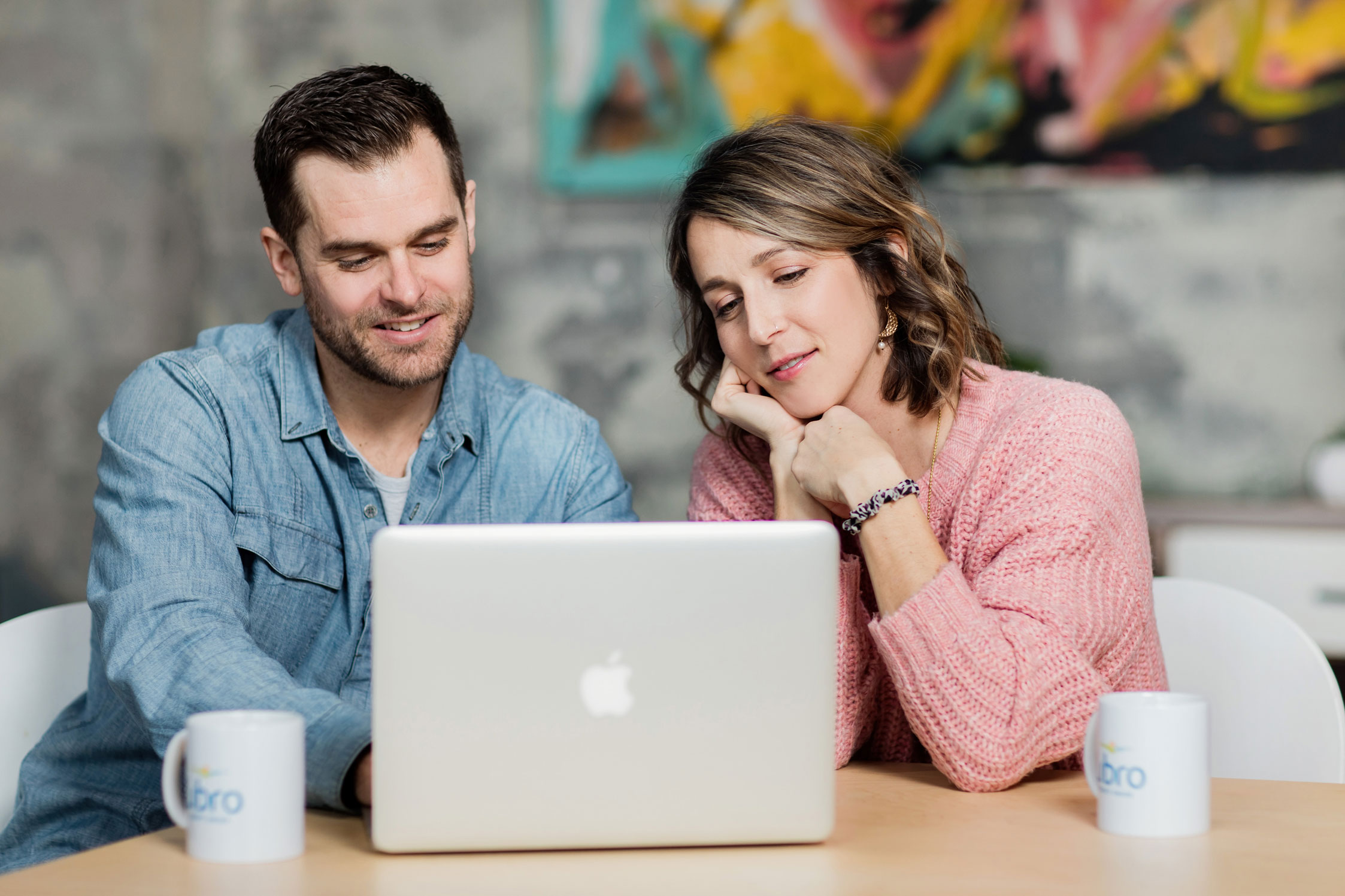 Libro Owners sitting at a table and looking at a Laptop