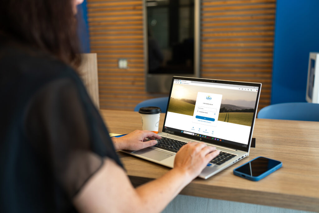 A person sitting at a laptop using online banking