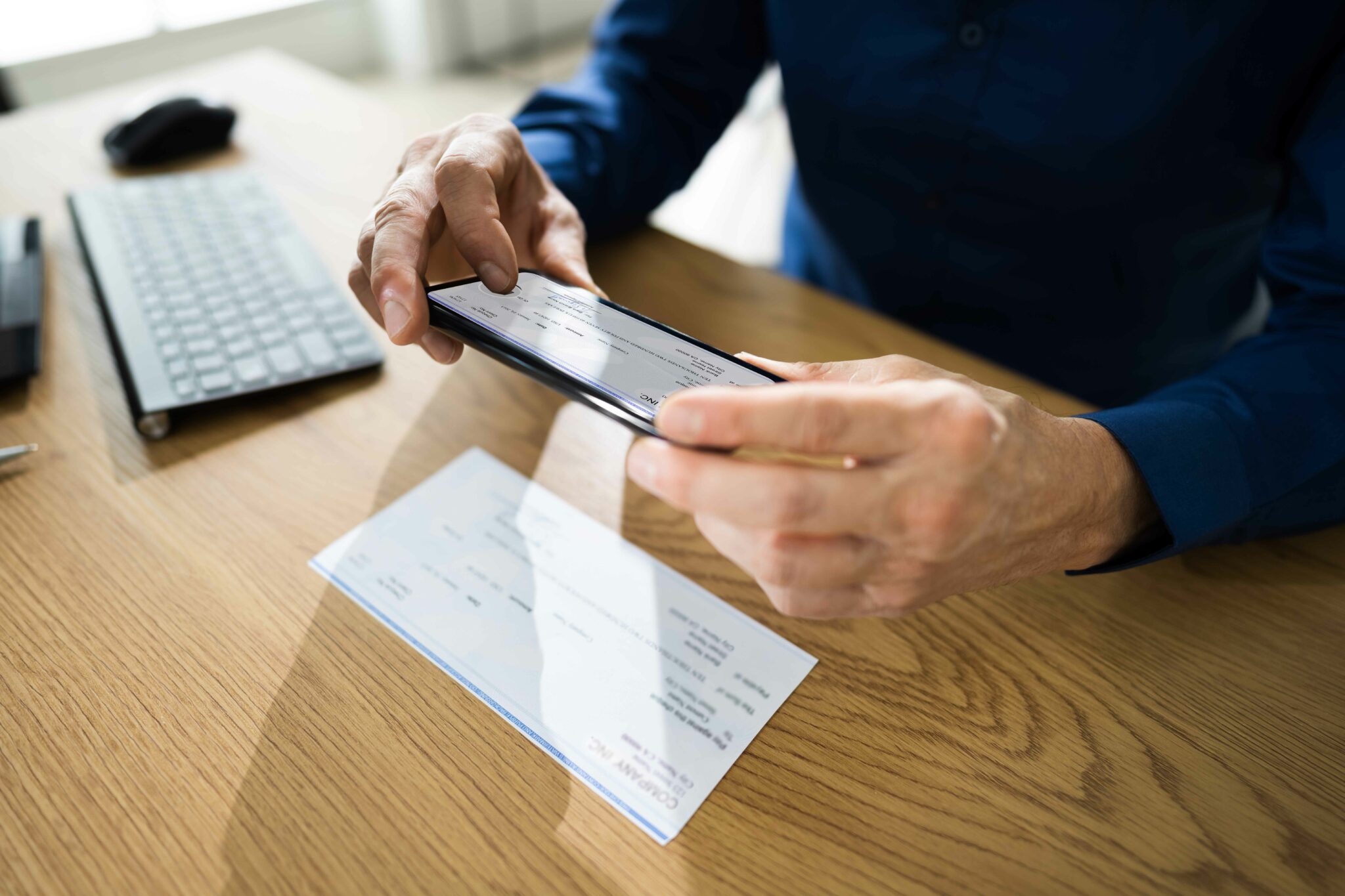 Man taking picture of cheque with phone