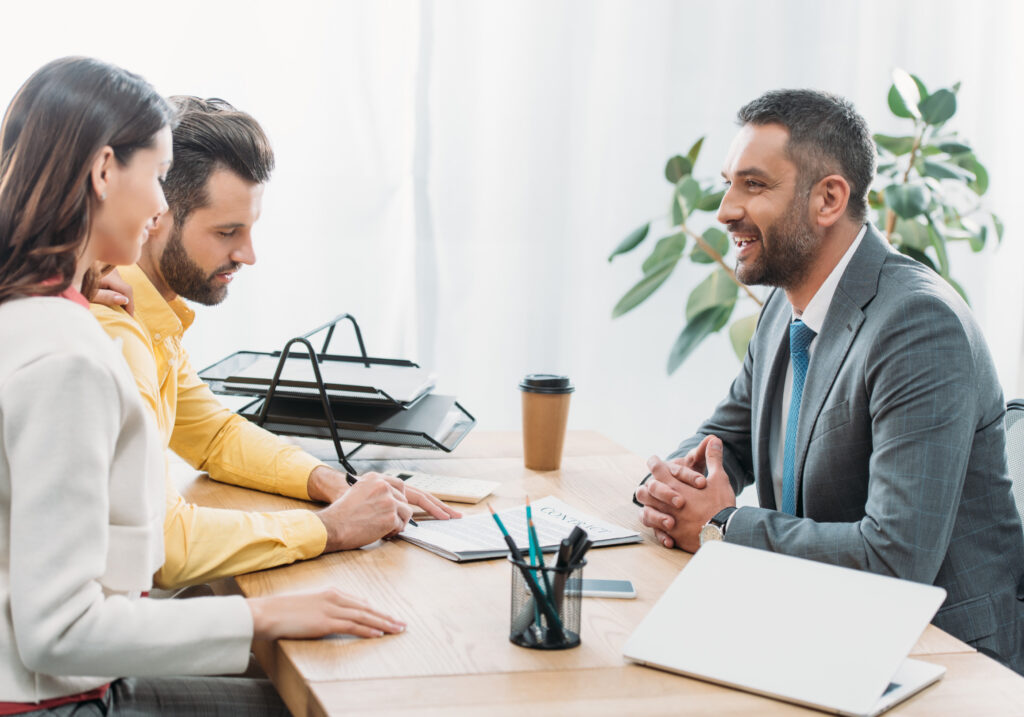 A couple sitting down with an investment coach