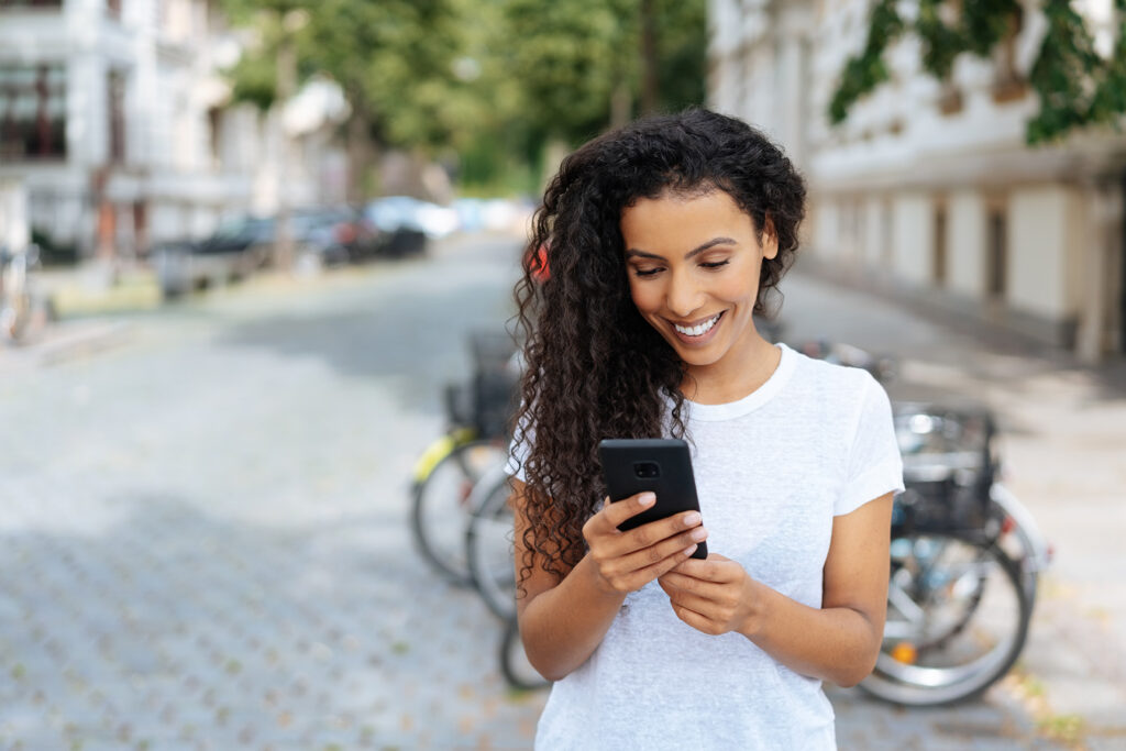 woman in street looking at phone