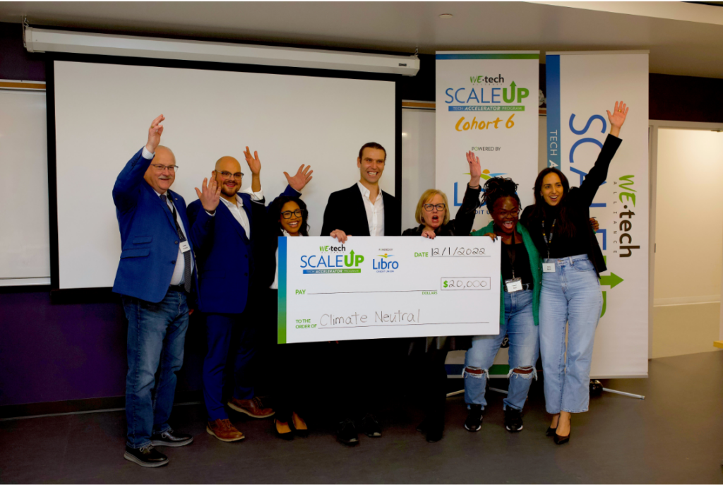 A group of people holding a giant cheque