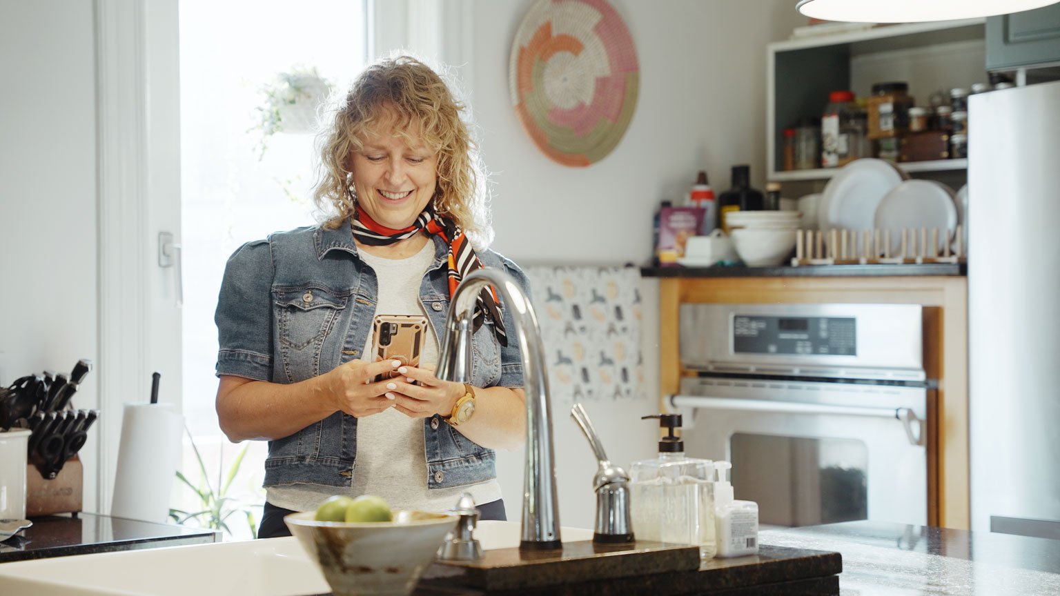 Libro Owner, Noella, smiling while looking at her phone