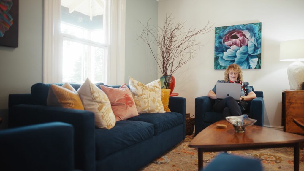 A decorative room with a Libro Owner using a laptop