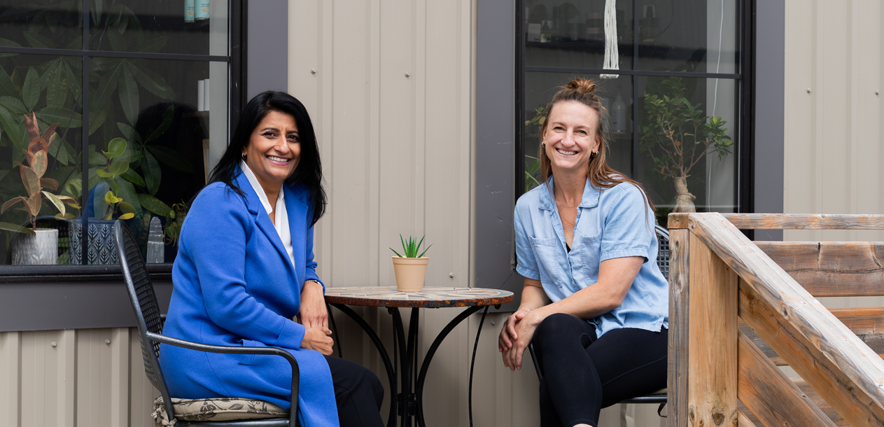 Libro Coach and Libro Owner sitting at a cafe table outdoors.