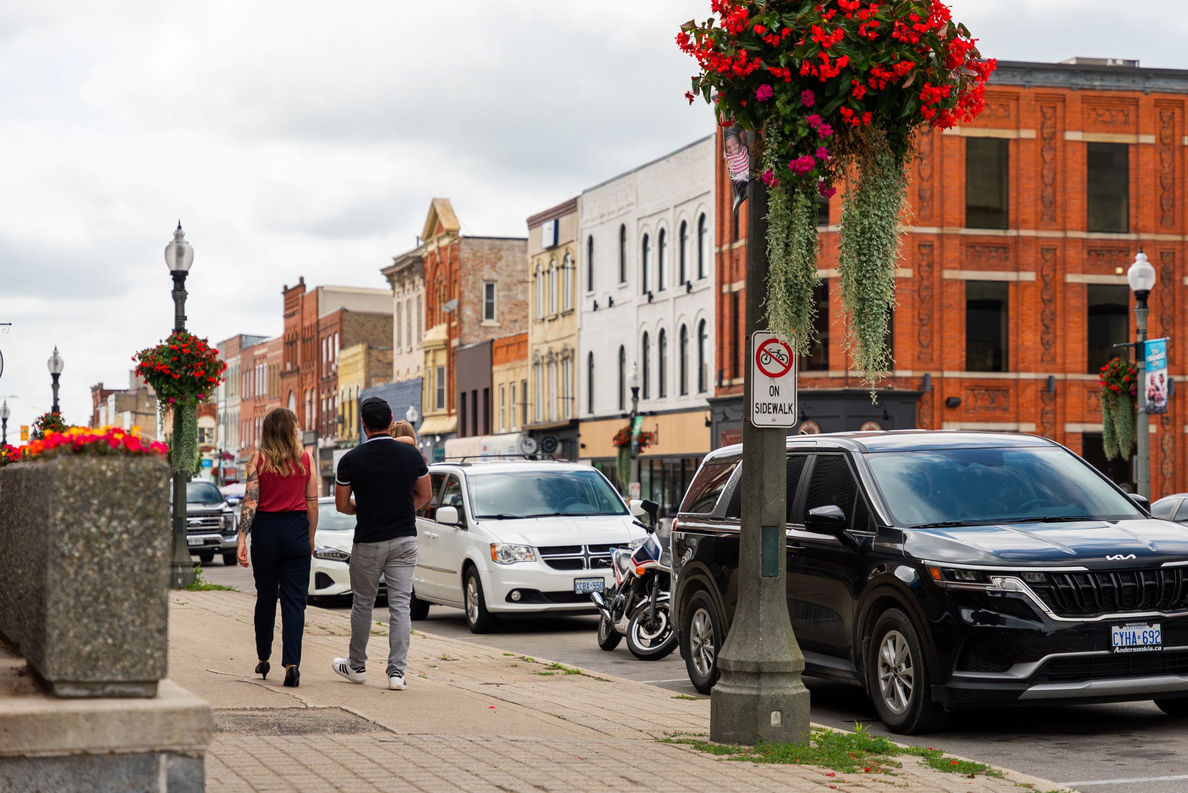 Couple with small child walking in downtown Woodstock, Ontario.