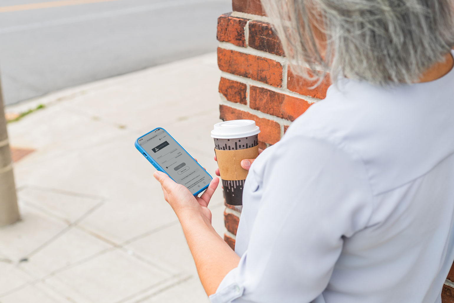 An Owner holding their phone looking at the CardWise app