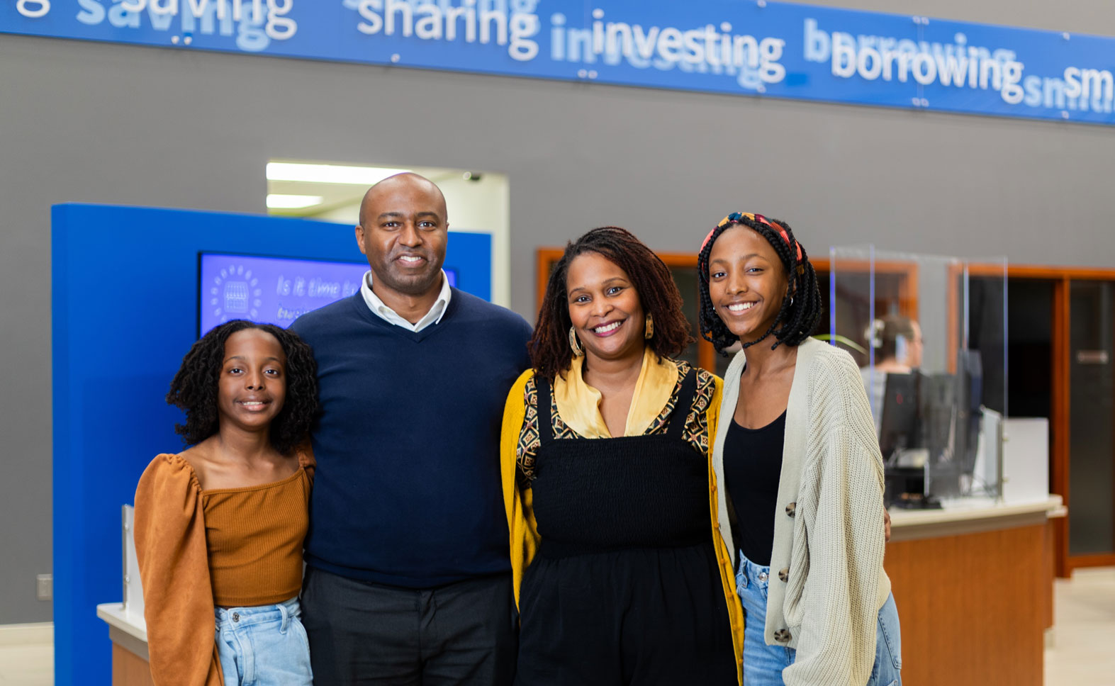 A family standing in a Libro location