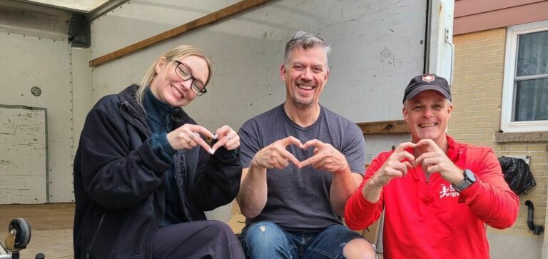 People smiling inside a large truck