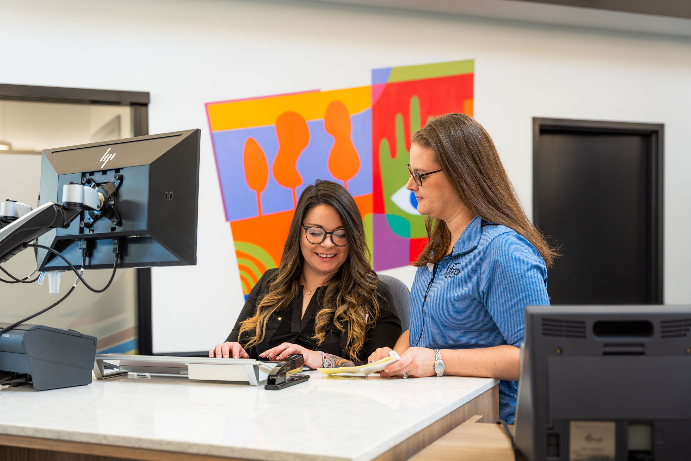Libro Staff in the St. Thomas branch at the wicket